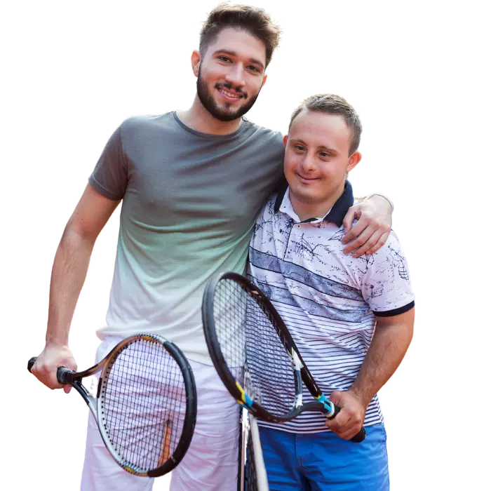 Disabled man with down syndrome holding tennis racket with friend
